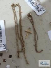 Gold colored cross pendant, marked 1/20 12K GF. Two gold colored necklaces, marked 1/20 12K GF.