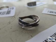 Silver colored ring with tiny clear and black stones, marked 925.