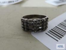 Silver colored band ring with sparkly stones, marked 925.