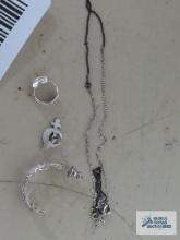 Variety of jewelry, all marked 925, including single earrings, pin, and necklace.