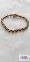 Gold colored bracelet with blue and clear stones (seller description sapphire and diamond), marked