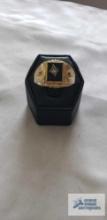 Gold colored ring with black stone and clear stone, marked 18KT HGE