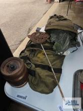 Independence wooden barrel safe, metal door needs reattached. Army bags and World War II placard.