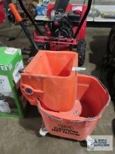 Orange commercial mop bucket, made by White