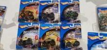 Six Hot Wheels Monster Jam monster trucks new in packages including Grave Digger, Sting, Predator,