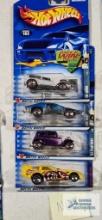 Three of the 2002 Redline Hot Wheels cars and one 2001 Extreme Sports series Hot Wheels car, new in