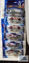Five 2004 Hot Wheels Flag series cars and one 2003 Hot Wheels Dragon series car, new in packages