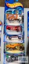 Four 2003 Work Crushers Hot Wheels cars and one Alt Terrain 2003 Hot Wheels car, new in packages