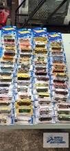 Fifty-nine 2001 Hot Wheels cars, new in packages