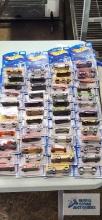 Forty-nine 2001 First Editions Hot Wheels cars, new in packages