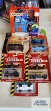 Matchbox Coca-Cola car, Looney Tunes cars, Haunted Castle adventure set, and Tonka cars, new in