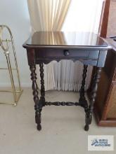 Antique accent table with turned legs.