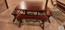 Redwood outdoor table with four benches, umbrella, and umbrella base. Umbrella has damage on top. in