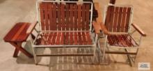 Redwood and aluminum outdoor settee and rocker and end table. In basement.