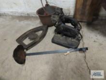 Cast iron lion bookends, miniature cast iron kettle, iron holder, and candle holder