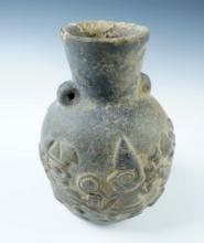5 3/4" tall x 3 3/4" wide Chimu Bottle in solid condition depicting a battle scene in relief.
