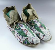 Beautifully beaded 9 1/2" pair of Vintage Leather Moccasins in nice condition. No visible bead loss.