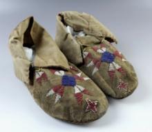 Pair of 8" Vintage Leather Moccasins with a nicely beaded design. Some damage to the heel on one.