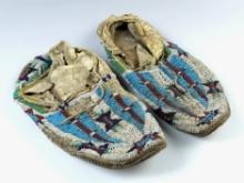 Pair of 9 1/2" long Beaded Leather Moccasins, both have some bead loss. Leather has hardened.