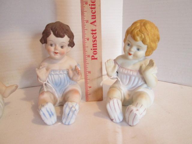 Seven Vintage Bisque Piano Baby Figurines