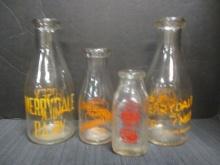 Four Old Glass Milk Bottles