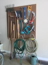 Contents of Peg Board-Shovels, Rakes, Hoe, Water Hose and Hangers, Hammers,
