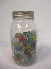 Ball Mason Jar Over Half Full of Marbles.