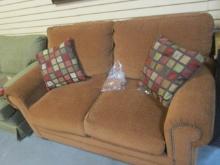 Bassett Rust Colored Loveseat with Nail Head Trim and Pair of of Pillows. Very Good Condition.
