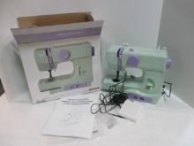 Janome Portable New Home Sewing Machine, In Original Box, Appears Unused.