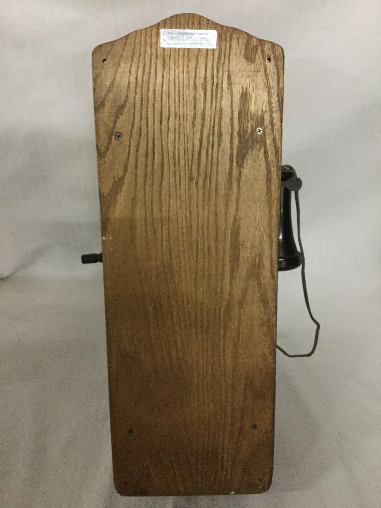Vintage T.D.Y. Telephone Company hand crank type wood wall phone with dial, phone line, and extra
