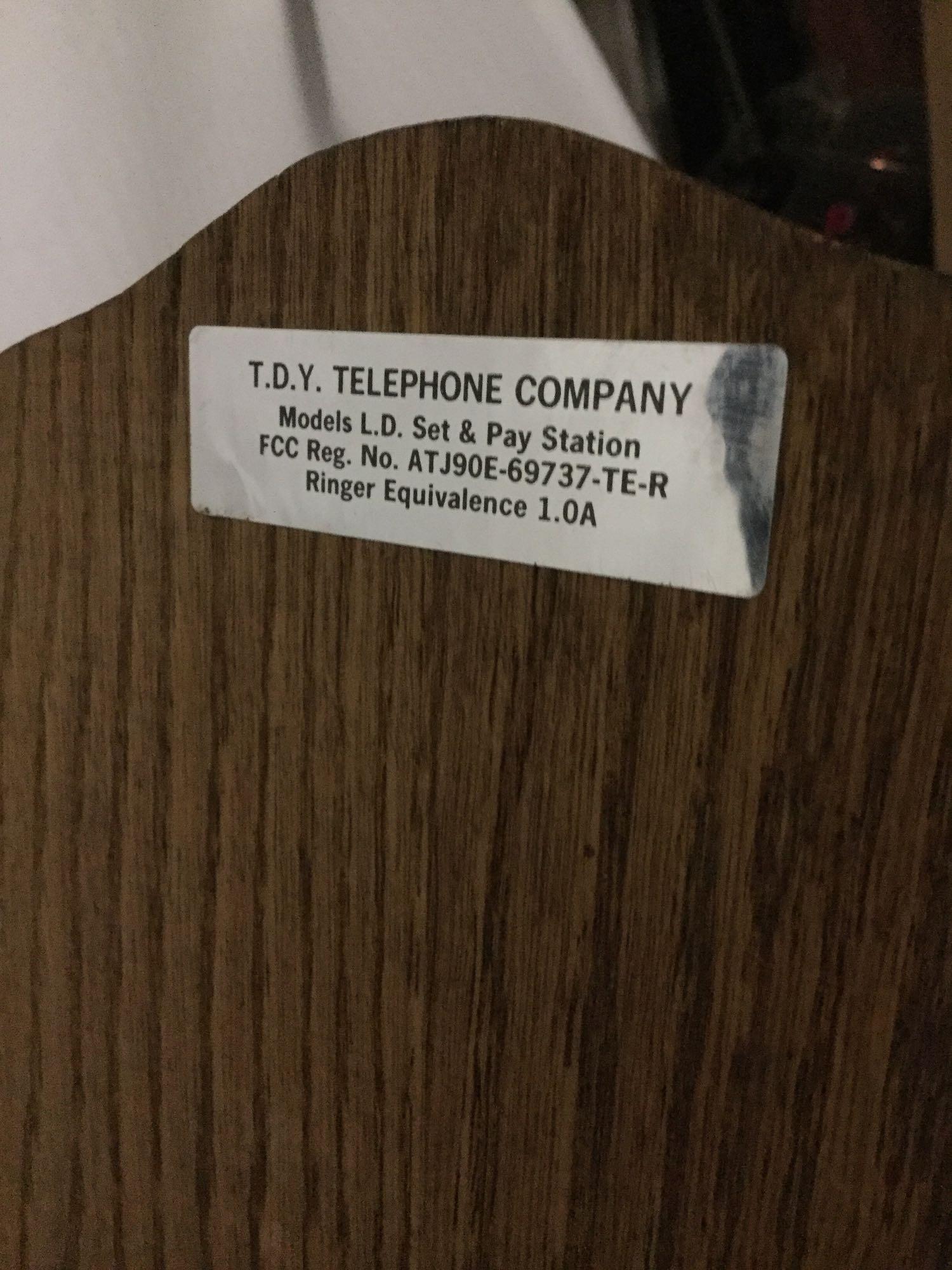 Vintage T.D.Y. Telephone Company hand crank type wood wall phone with dial, phone line, and extra