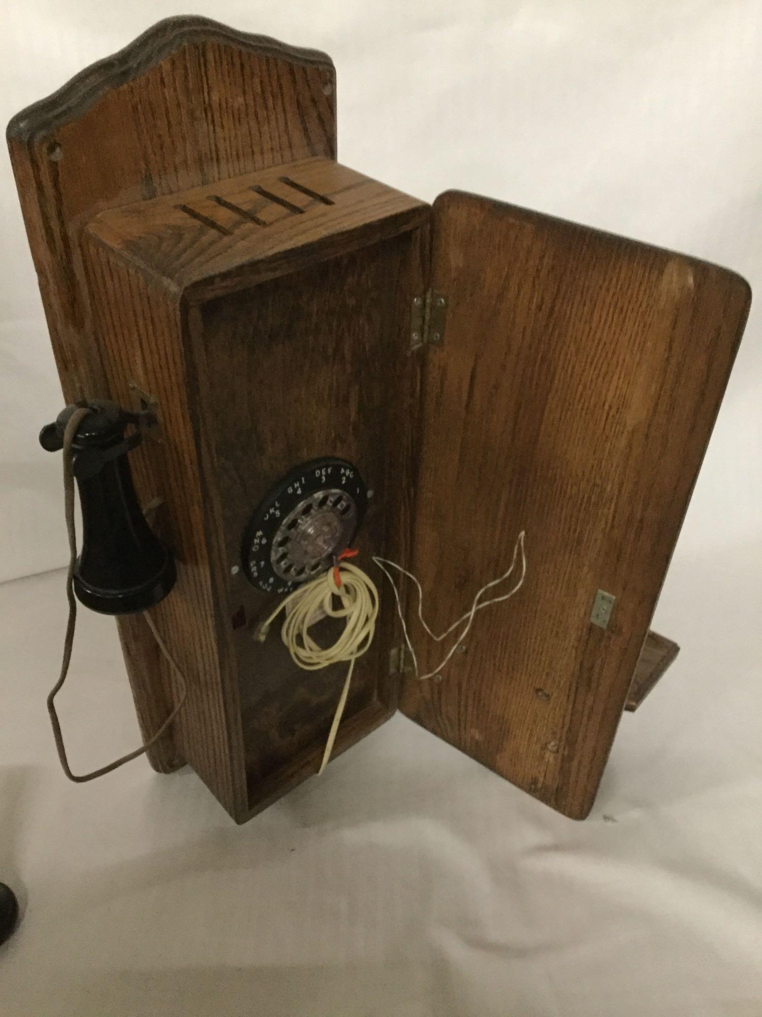 Vintage T.D.Y. Telephone Company hand crank type wood wall phone with dial, phone line, and extra