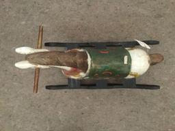 Antique wooden rocking horse with colorful painted adornments and dark base