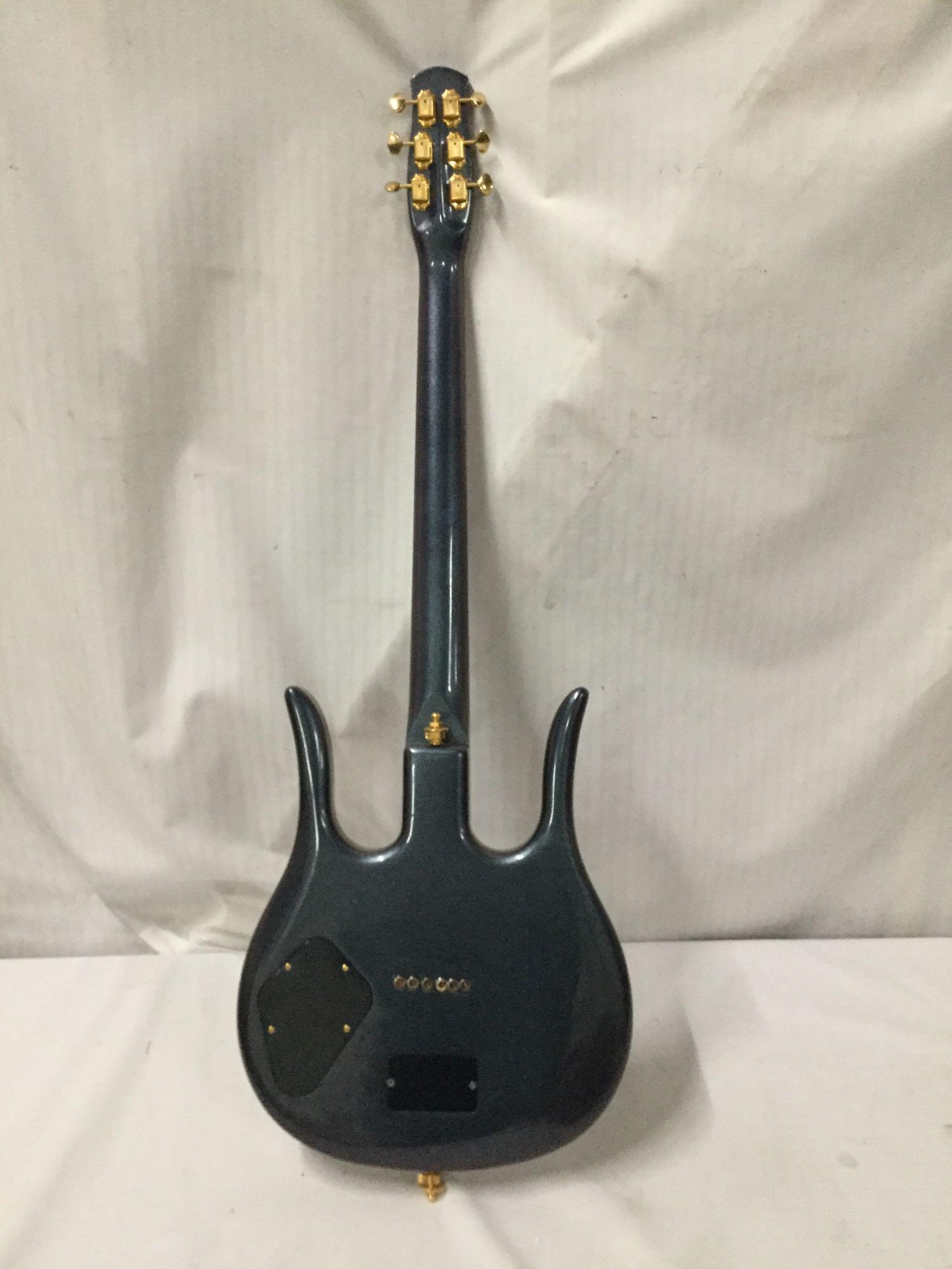 Custom modified Danelectro Longhorn electric guitar w/ burled maple top and custom fitted hard case.