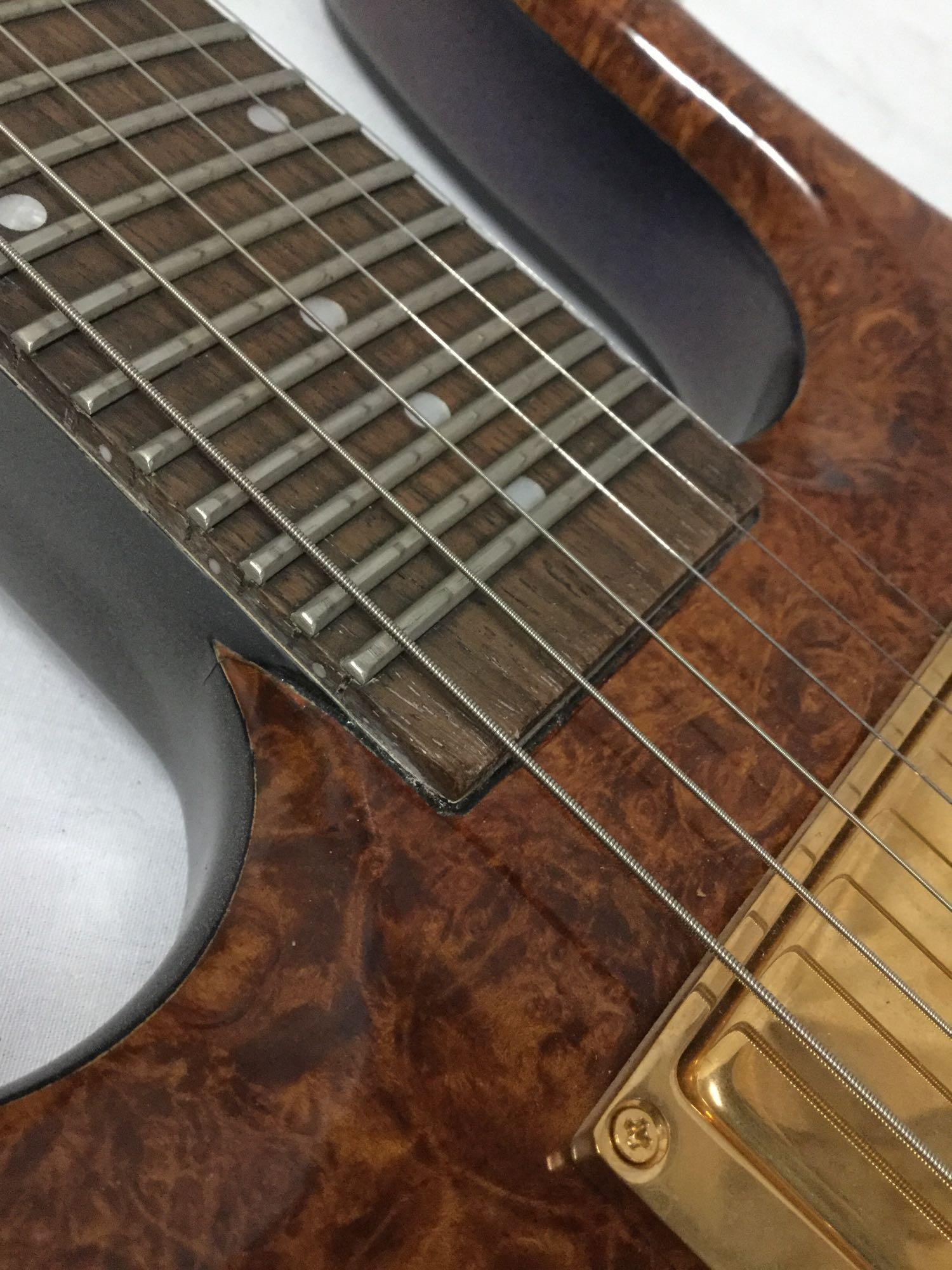 Custom modified Danelectro Longhorn electric guitar w/ burled maple top and custom fitted hard case.