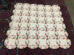 Large vintage hand made quilt feat. an overlapped circular pattern with some light wear