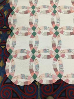 Large vintage hand made quilt feat. an overlapped circular pattern with some light wear