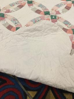 Large vintage hand made quilt feat. an overlapped circular pattern with some light wear