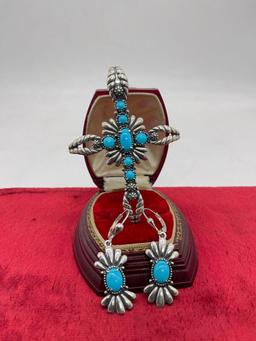 Large sterling silver floral accented cross pendant with blue stone cabochons and matching earrings