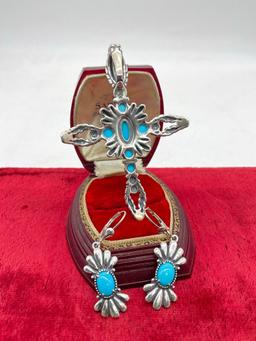 Large sterling silver floral accented cross pendant with blue stone cabochons and matching earrings