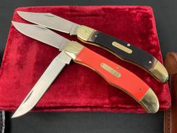 Pair of Schrade NIB Large Trapper Knives, Models 125OT & 25OTO, Black and Orange Handles w/ Sheaths