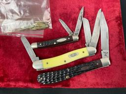 Trio of Case XX Folding Pocket Knives, models 3318 shsp, 6227, 61048 SS, bag of Case Knife emblems