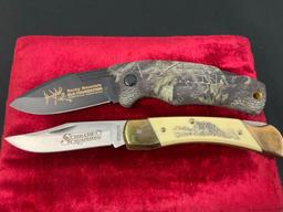 Pair of Schrade Folding Pocket Knives, models SG8RM & LB7YW Scrimshaw w/ Wolf Scene w/ Sheaths