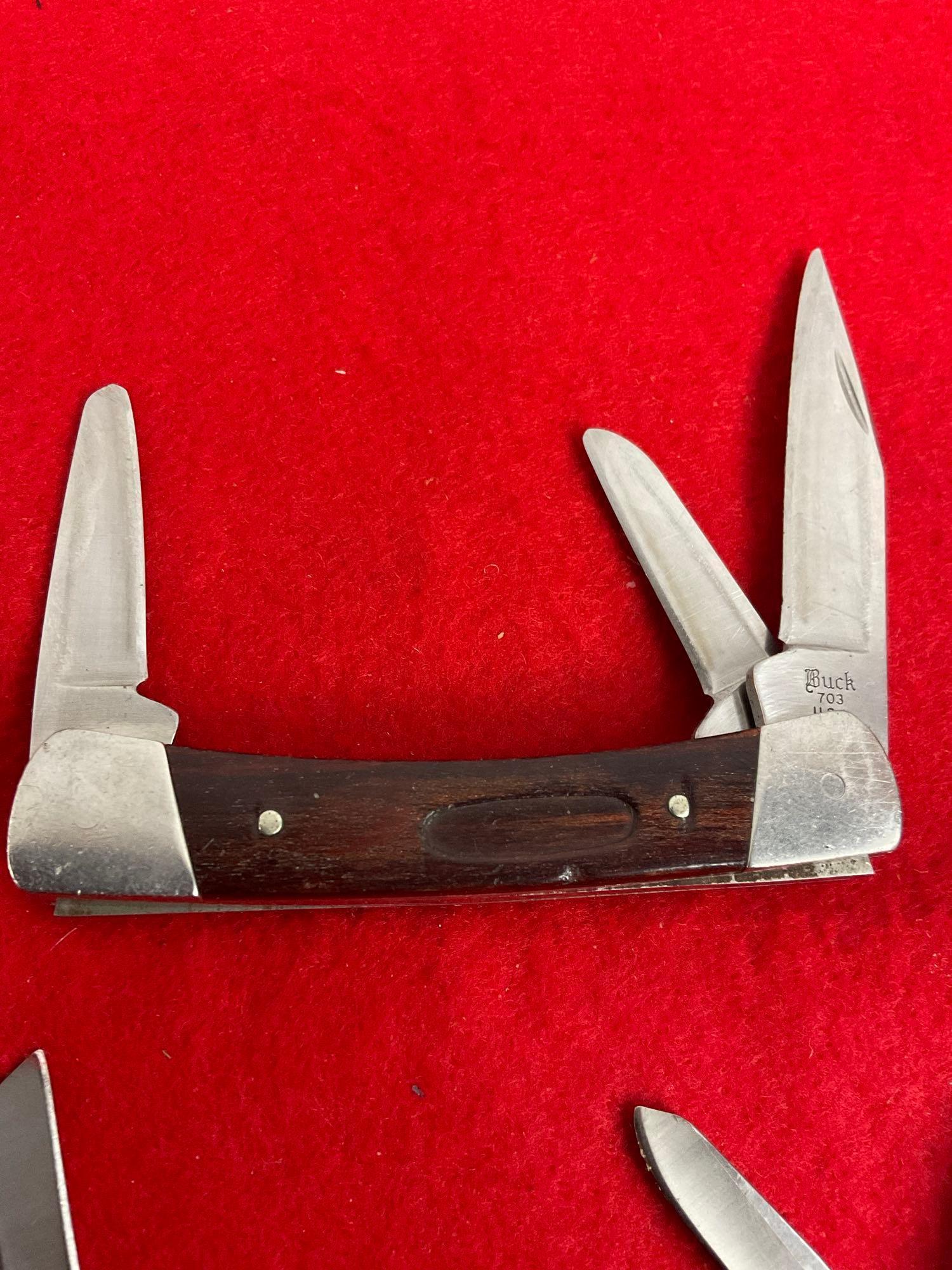 Collection of 4 Buck Folding Blade Pocket Knives Numbered - 703, 501+, 303, & 313.