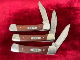 Trio of Vintage Buck Folding Pocket Knives, 704 Maverick, wooden handles