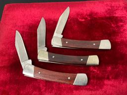 Trio of Vintage Buck Folding Pocket Knives, 704 Maverick, wooden handles