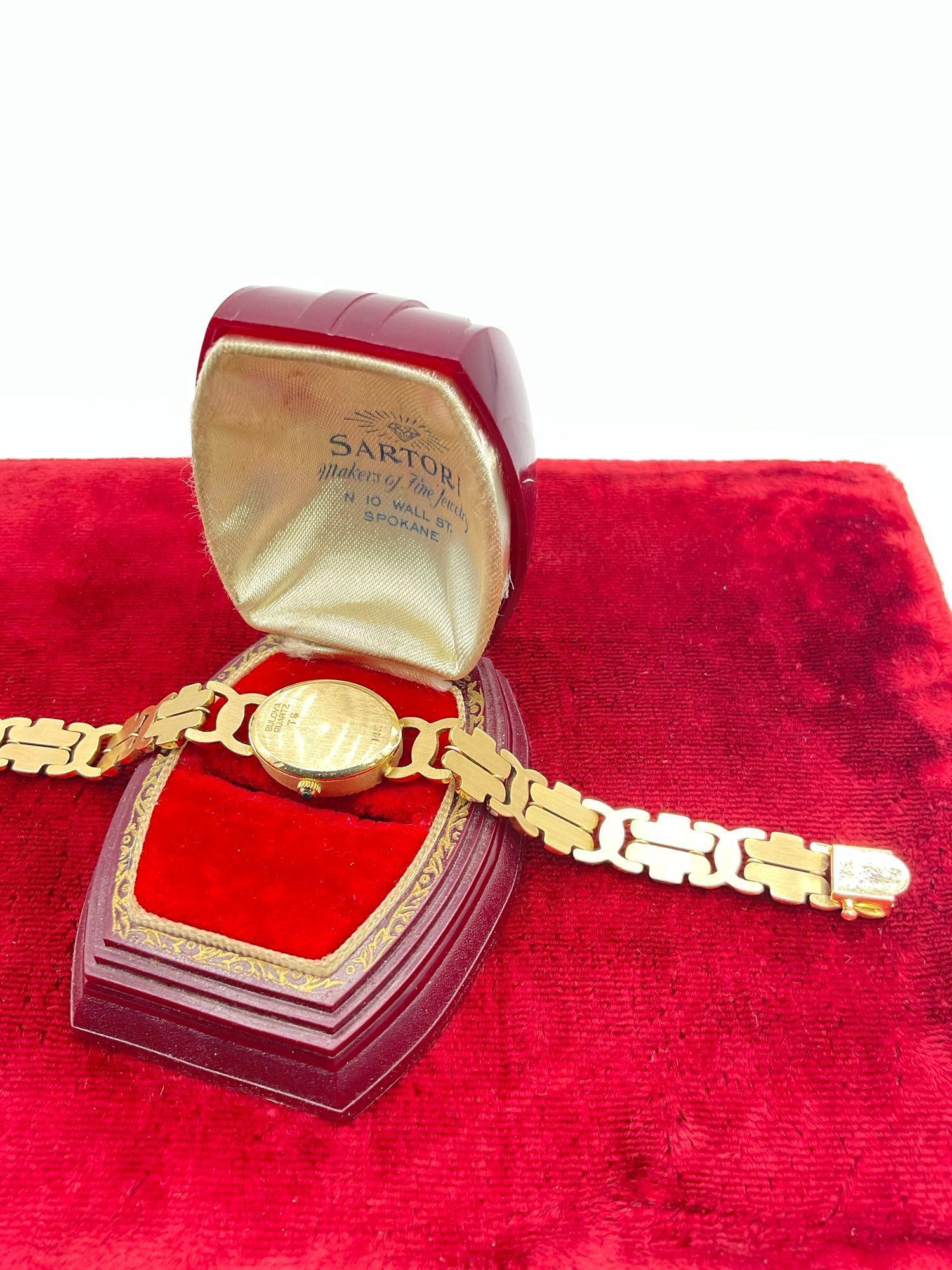 Women's Bulova 14k gold case and 14k band wristwatch w/16 diamonds, swiss quartz movt.