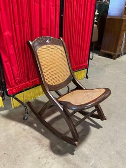 Beautiful Antique Wooden Folding Rocking Chair w/ Caned Seat & Floral Carved Back. See pics.