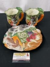 3 Fitz & Floyd Ceramic Pieces, platter & 2 Mugs w/ Rabbit and Vegetable motif