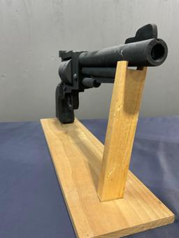 Large Wooden Revolver Figure painted black w/ Stand, the gun is 10h x 24L inches